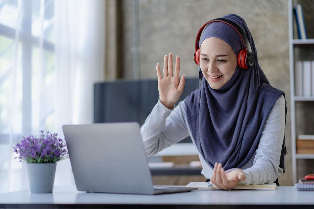 Muslim Female Student In Hijab Studying Online With Laptop